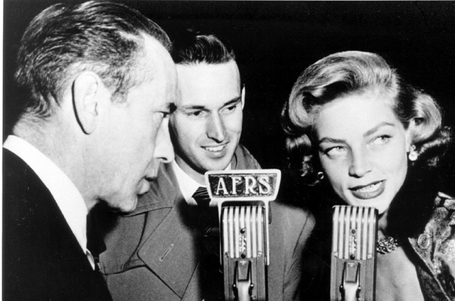 An old fashioned photo of people singing