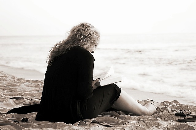 A lady reading on the beach