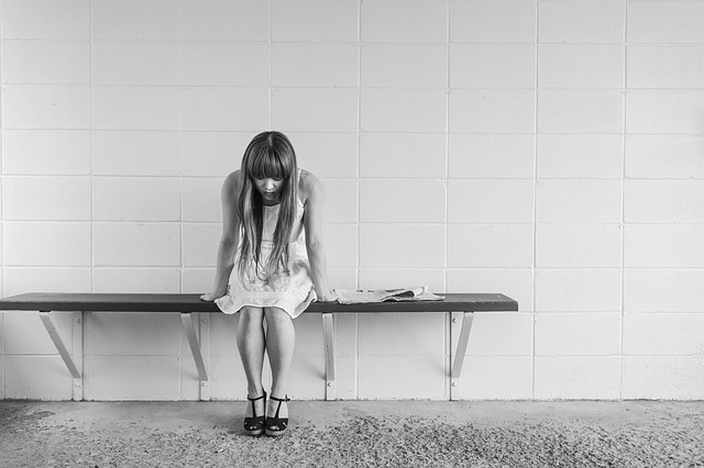 A lonely girl on a bench