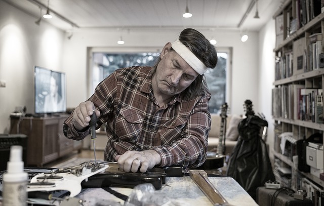 Man fixing a guitar